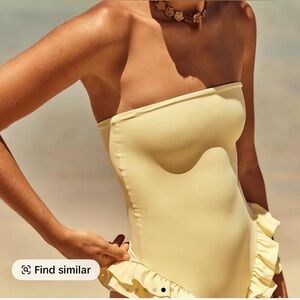 Women’s medium yellow one piece bathing suit with side ruffles. Size med. NWOT